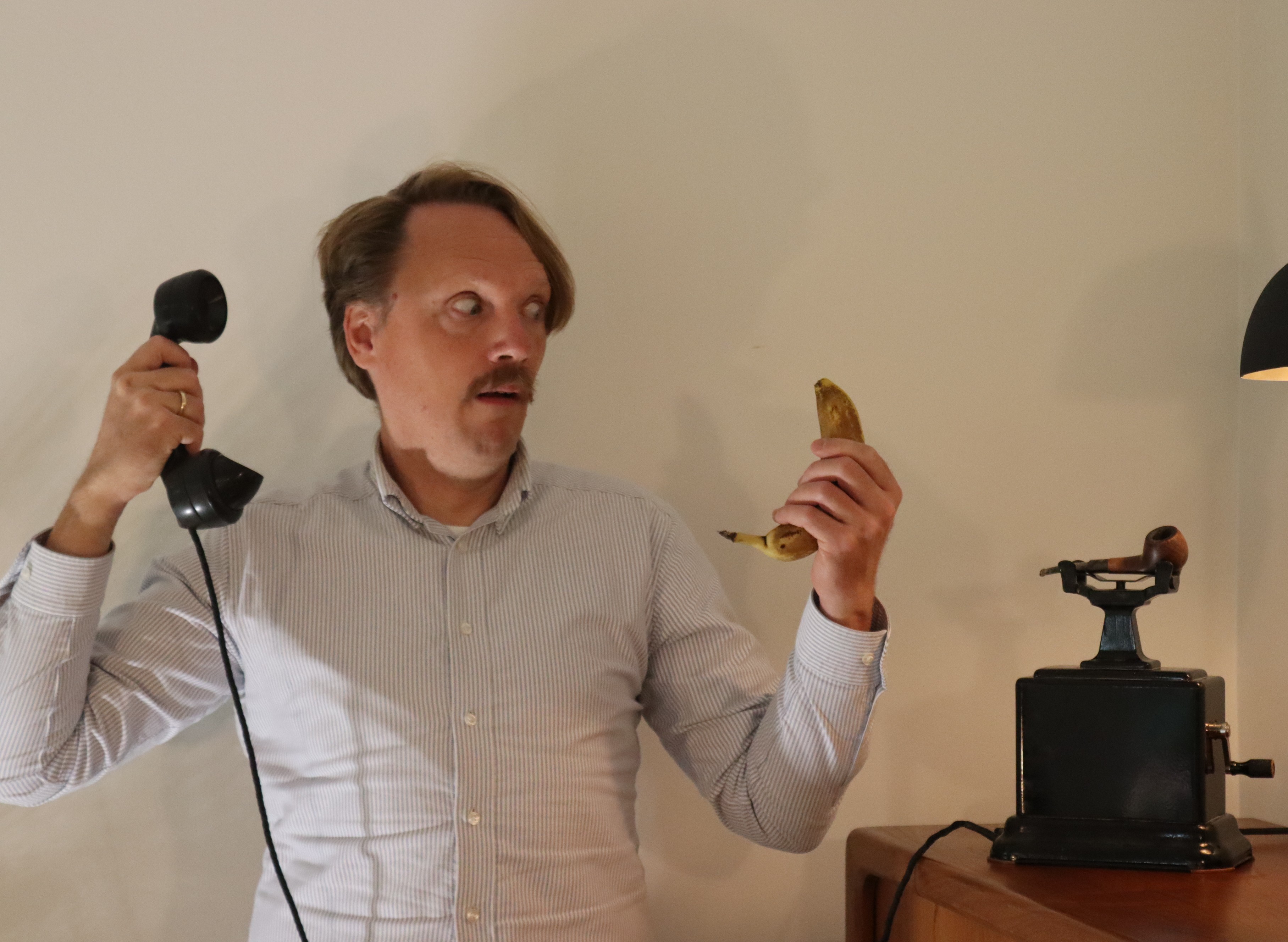 Nicolaj holding a telephone receiver and a banana